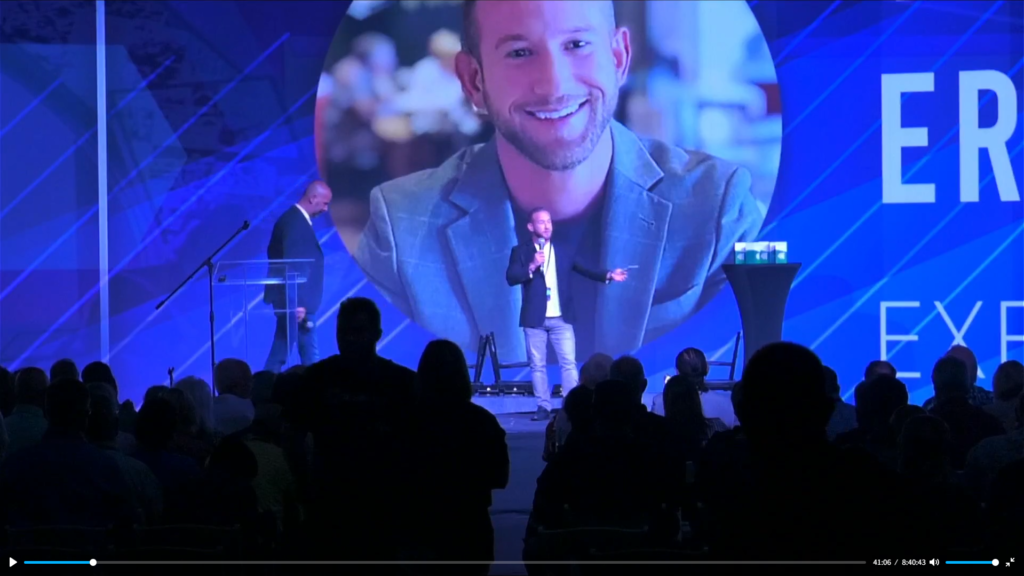 Eric Zhivalyuk Speaking on Stage in Las Vegas at iHub Global and iHub Meta Event at Vu Studios ewoah