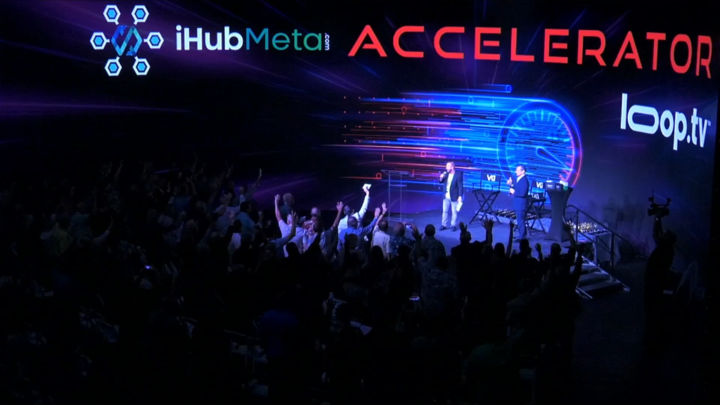 Roaring Crowd with Eric Zhivalyuk Speaking on Stage in Las Vegas at iHub Global and iHub Meta Event at Vu Studios ewoah